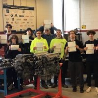 Group photo of all 300 level automotive technollogy students holding their certificates