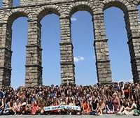 central bucks students stand before an aquaduct in spain
