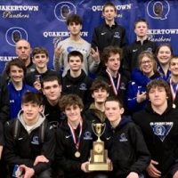 Quakertown Community High School's wrestling team and coaches pose for a photo with the Liberty Division trophy.