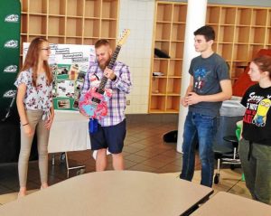 students presenting guitars to local veterans.