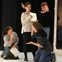 photo of students on stage acting